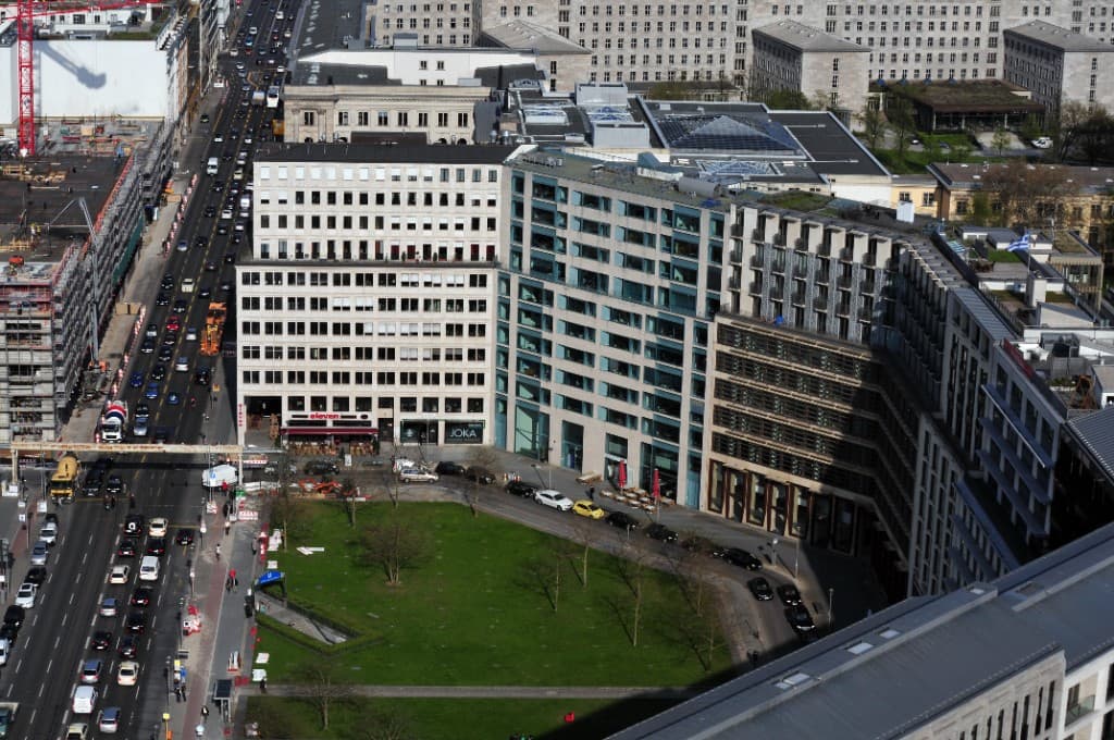 Aerial view of a modern city district with office buildings and a green courtyard